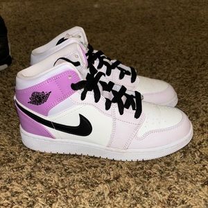 Woman’s purple jordan one mids
